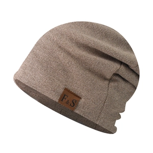 Close-up of brown knit beanie showing fine texture and F&S leather patch detail