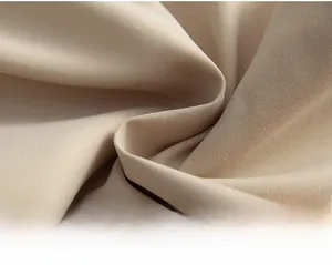 Detailed close-up of beige twill woven fabric showing texture of American cargo pants