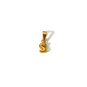 Macro shot of gold-plated letter S bubble pendant with polished finish and bail