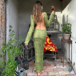 Detail of green open back knit maxi dress showing sheer hollow out texture and long sleeves
