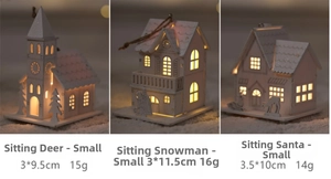 Detailed view of three white glowing wooden Christmas house ornaments with LED lights and sizes