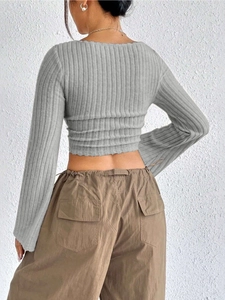 Back view of grey ribbed knit long sleeve crop top with square neck on model
