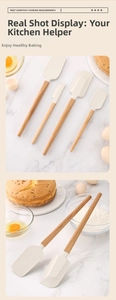 Detail view of silicone baking spatula set with beech wood handles on marble surface
