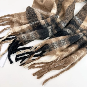 Close-up of brown and black plaid mohair scarf with soft texture and long tassels