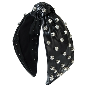 Fashionable faux leather knotted headband with silver rhinestones on white background