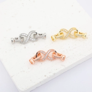 Macro shot of 18K gold plated infinity jewelry clasps with zircon stones in three colors