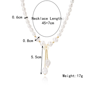 Layered baroque pearl necklace featuring a white flower pendant and golden chain drops