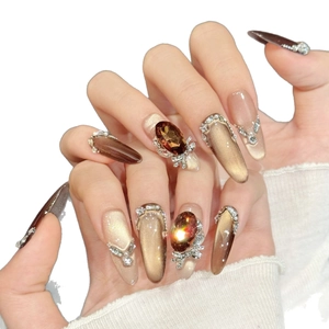 Champagne cat-eye press-on nails with amber gemstones and luxury diamond accents