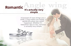 Close-up of silver-plated angel wing couple rings with sparkling diamond accents