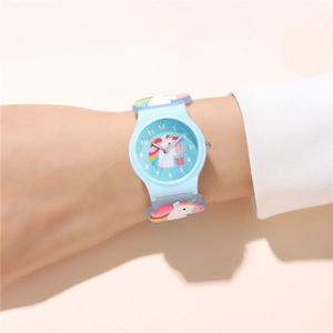 Close-up of a blue silicone kids watch featuring a cute unicorn pattern on a child's wrist