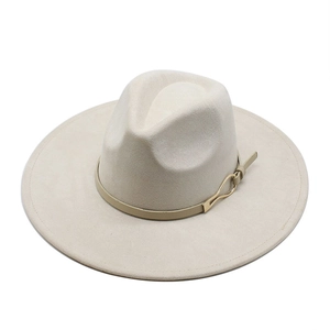 Detail view of the elegant beige suede fedora featuring a leather band with gold buckle