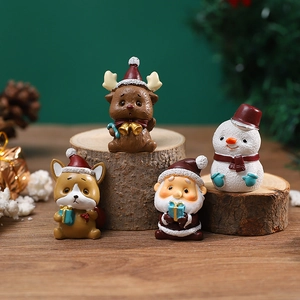 Miniature Christmas resin figurines of Santa, reindeer and snowman on a wooden log base