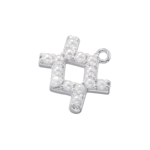 Macro view of silver constellation pendant with white pearls on a white background
