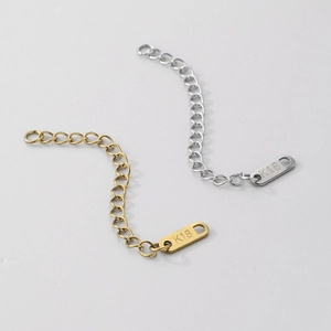 Macro detail of 18K gold and silver stainless steel extender chains with K18 tag