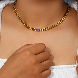 Close-up of 18K gold-plated Cuban chain necklace featuring a purple round zircon stone