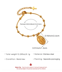 Close-up of gold stainless steel beaded bracelet with Virgin Mary and cross pendants