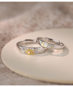 Macro shot of S925 sterling silver sun and moon rings with matte and polished details