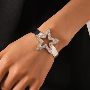 Close-up of sparkling star-shaped silver cuff bracelet with crystal inlay on arm