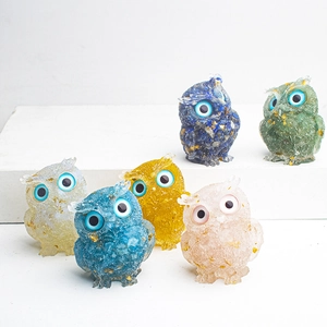 Group of six resin owl figurines with colorful natural crystal stones and gold leaf accents