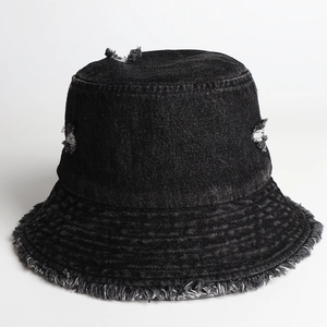 Close-up of dark grey denim bucket hat featuring distressed torn holes and frayed edges