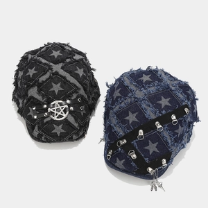 Detail of washed denim berets with frayed edges, star prints, and metal punk ornaments
