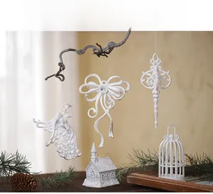 Detailed view of white vintage Christmas ornaments hanging on branches with warm pine decor