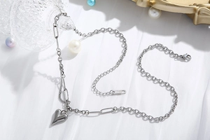 Dettaglio della collana con ciondolo a cuore argento e catena a maglie miste eleganti