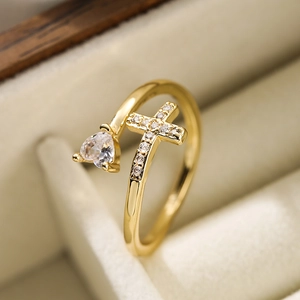 18K gold plated heart and cross open ring with zircon stones on a beige velvet box