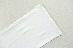 Macro detail of high-quality double-needle stitching on the white dress hem or cuff edge