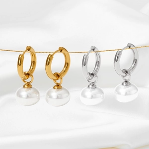 French vintage pearl drop earrings in gold and silver finish on white silk background