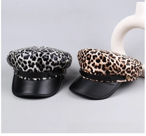 Detail of leopard print baker boy caps with leather brim and rivet belt decoration