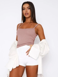 Detail of dusty pink ribbed knit camisole with delicate lace trim and soft texture