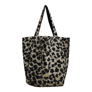 Faux fur leopard print tote bag with plush texture and handmade metal nameplate detail