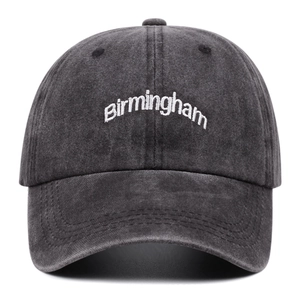 Detailed macro view of vintage dark grey cotton baseball cap with white Birmingham embroidery