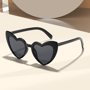 Fashionable women's heart-shaped sunglasses with black frames and dark grey lenses