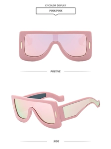 Detailed front and side views of pink oversized futuristic one-piece shield sunglasses