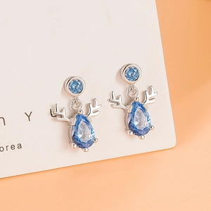 S999 sterling silver reindeer earrings with blue teardrop stones on white jewelry card