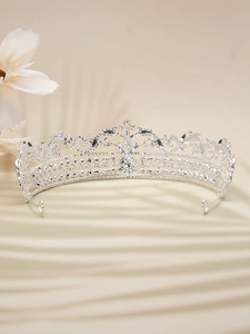 Detail of silver bridal crown featuring sparkling crystals and vintage metal ornaments