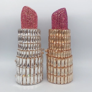 Detail view of lipstick shaped evening clutches with sparkling rhinestones in silver and gold