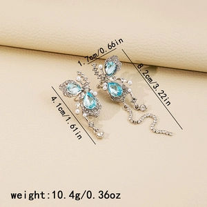 Detail view of blue butterfly drop earrings showing dimensions 1.7cm width and 8.2cm length