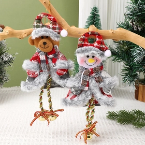 Hanging Christmas ornaments featuring bear and snowman figures with bells on wood branch