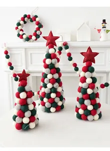 Detailed view of handmade wool felt Christmas trees and garland in Nordic festive style