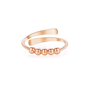 Close-up of rose gold anxiety ring featuring five movable beads on an adjustable band