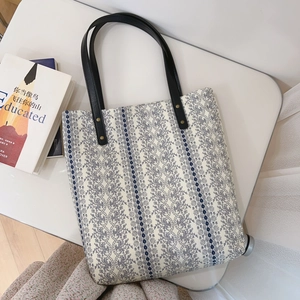 French floral cotton tote bag with black leather handles and blue lace pattern