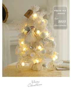 Detail of 60cm white flocked Christmas tree with angel wings topper and warm LED lights