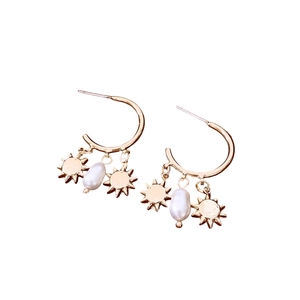 Golden C-shaped hoop earrings with sun charms and pearl pendants in a vintage style
