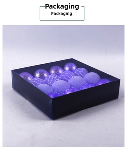 Detail view of purple Christmas balls with glitter and snow patterns in a blue gift box