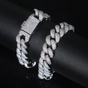 Close-up of 15mm silver Cuban chain with shimmering diamonds on a sleek black stand