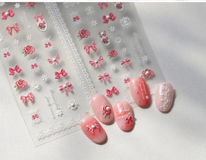 Detail of 3D embossed pink bow and rose nail art stickers with lace accents