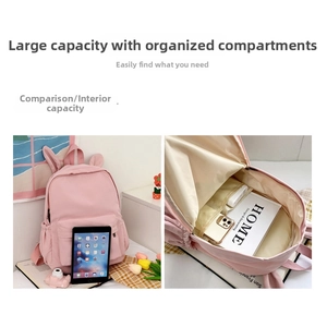 Detailed view showing large capacity interior and cute rabbit ears on pink school backpack